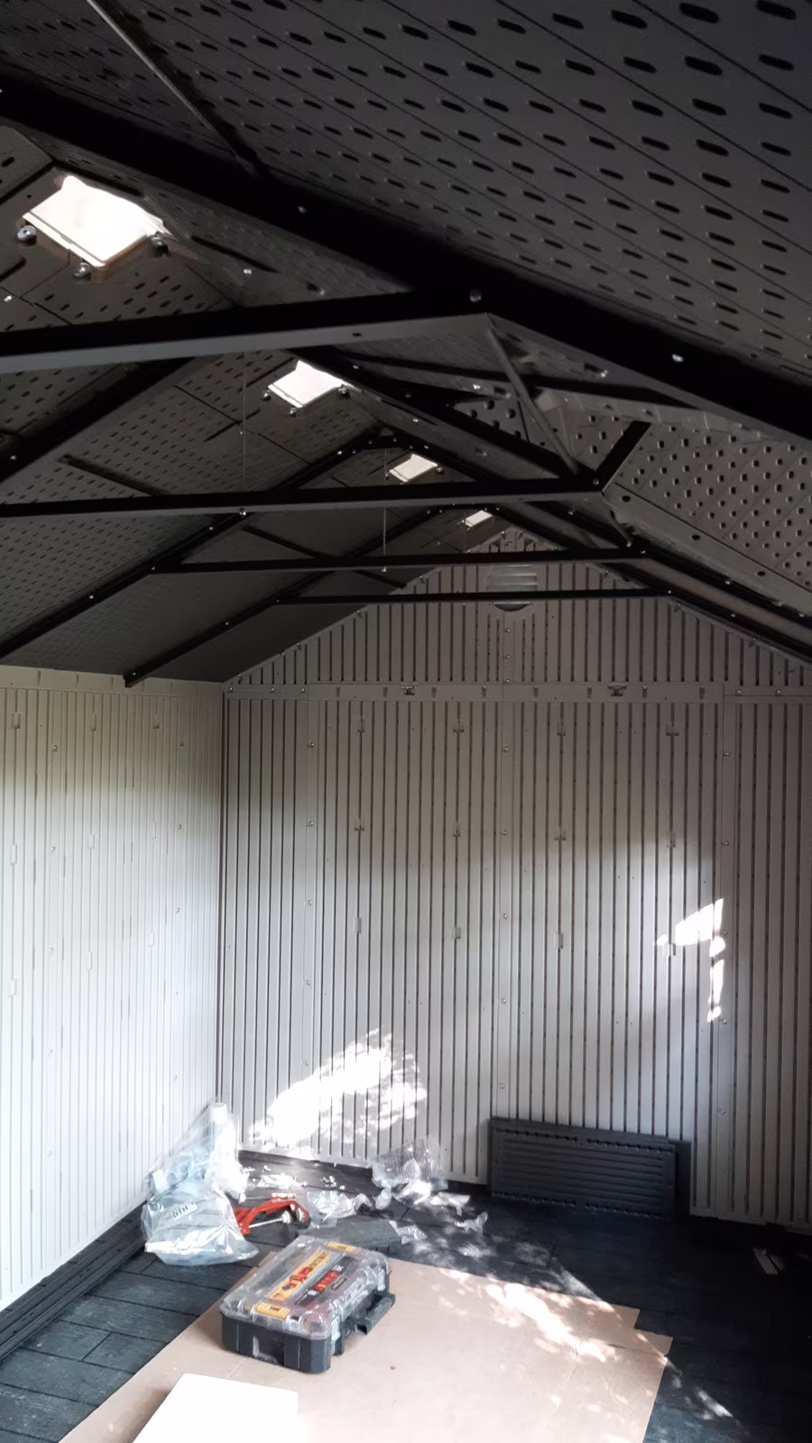 Inside the same shed with the roof up and the floor in